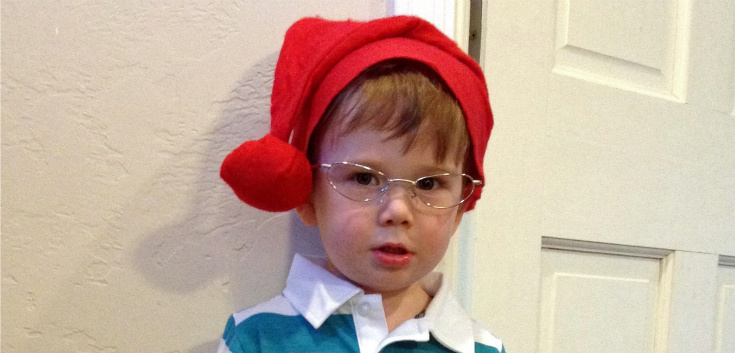 kid wearing a red knit cap and glasses