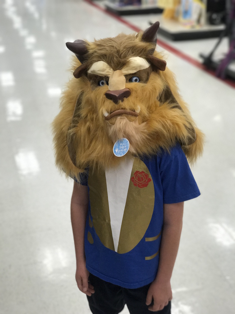 Kid wearing a beast costume mask and beauty and beast costume t-shirt