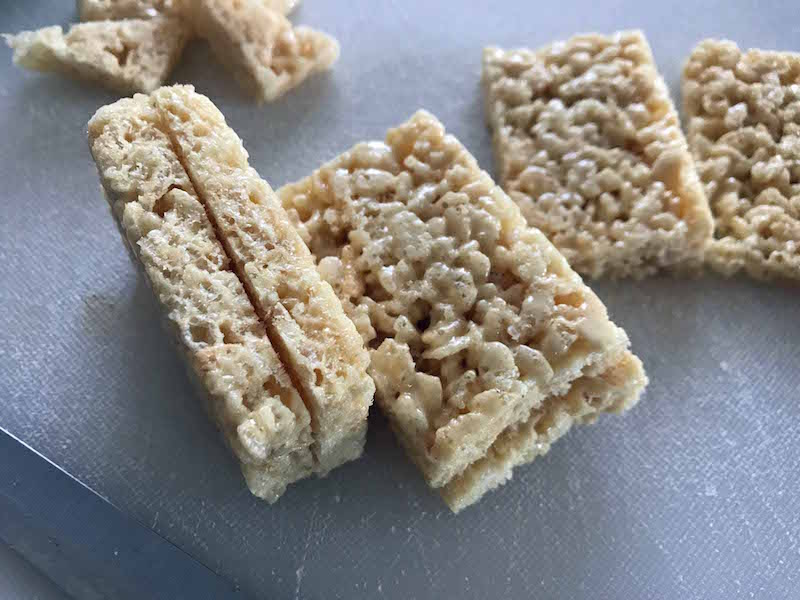 Slice pre made rice Krispies Treats in half lengthwise for your easy Rice Krispies Gingerbread House