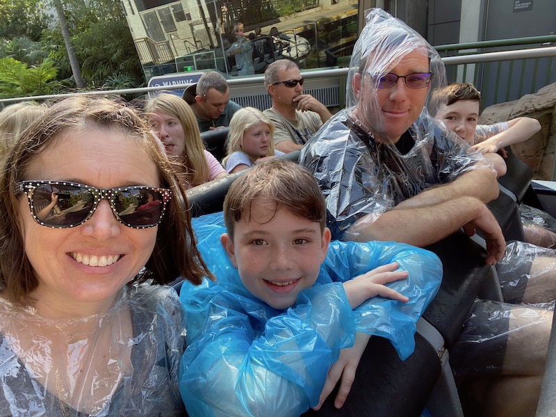 family wearing ponchos on a Jurassic World water ride at Universal Hollywood