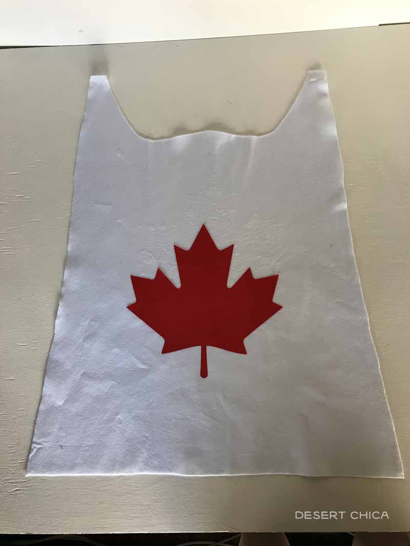 white cape with red maple leaf