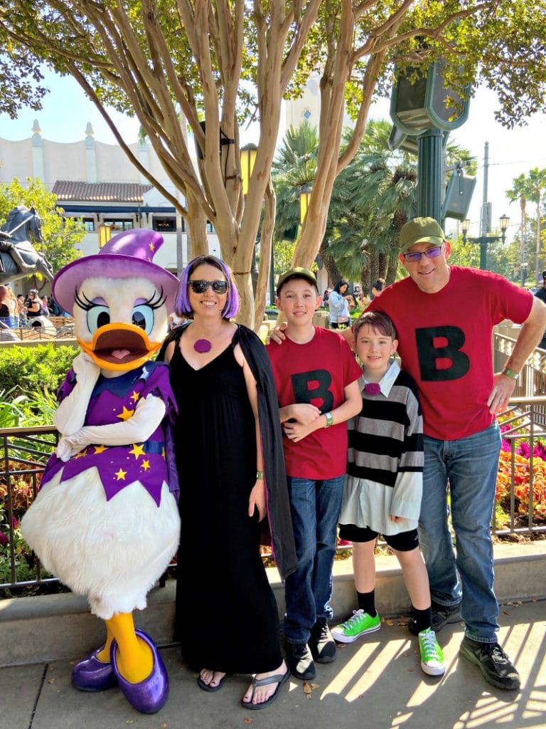 DuckTales Costume Family Meets Daisy Duck dressed as a witch at Disneyland's Oogie Boogie Bash