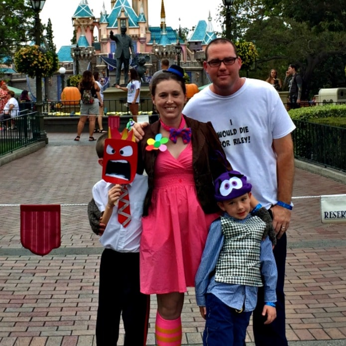 Family in front of Disneyland castle dressed up as characters from Inside Out