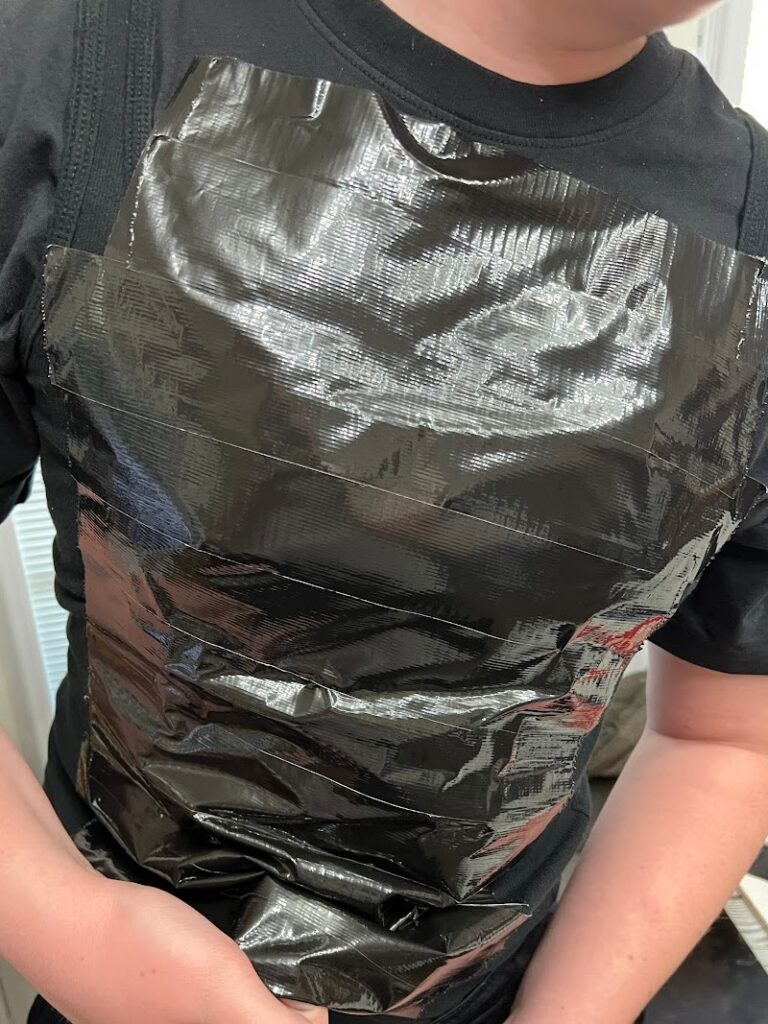black duct tape across a black shirt