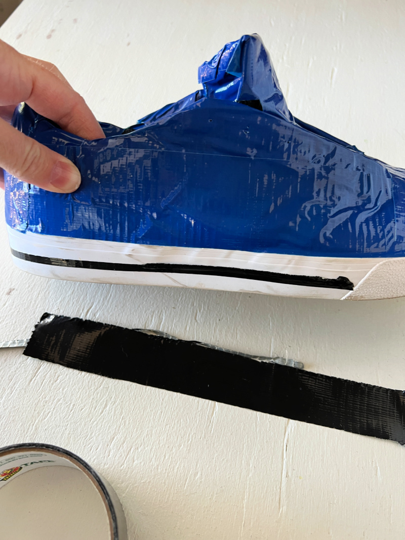 blue duct tape shoe with black stripe on it