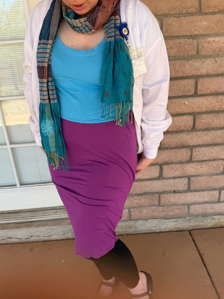 DIY Olivia Octavius costume from Spider-Verse with a white lab coat, blue shirt, purple dress and colorful scarf.