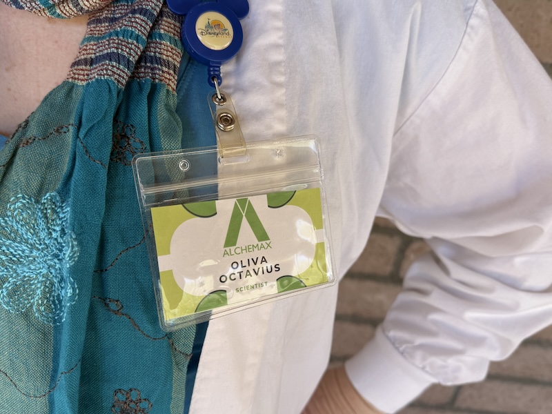 DIY Olivia Octavius Alchemax scientist name badge clipped to a white lab coat for a Spider-Verse costume.